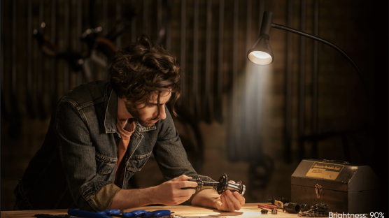 Person working on a project with the floor lamp lighting the area.